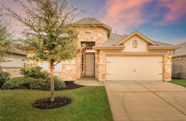 5141 Cornetto Blfs, Round Rock, TX 78665 - view of front facade featuring stone siding, concrete driveway, a garage, a yard, and stucco siding