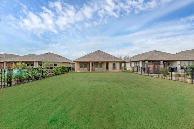 back of property with fence and a lawn