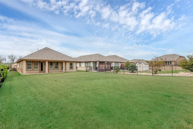 back of house featuring a yard and fence