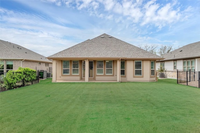 back of property with central AC, a yard, fence, stucco siding, and roof with shingles