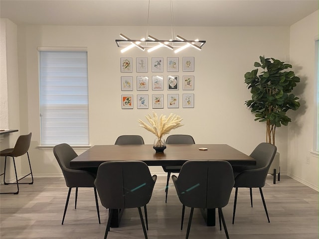 7900 Nightwing Rd, Austin, TX 78724 - dining space featuring baseboards, a chandelier, and light wood-style floors