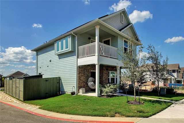 9615 Morning Iris Dr, Manor, TX 78653 - view of side of home with a lawn, fence, and a balcony