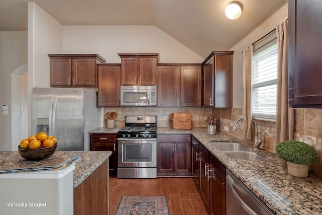 5660 Sabbia Dr, Round Rock, TX 78665 - kitchen with stainless steel appliances, lofted ceiling, tasteful backsplash, light stone countertops, and dark wood finished floors