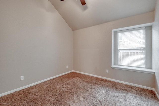 empty room featuring a ceiling fan, carpet flooring, lofted ceiling, and baseboards