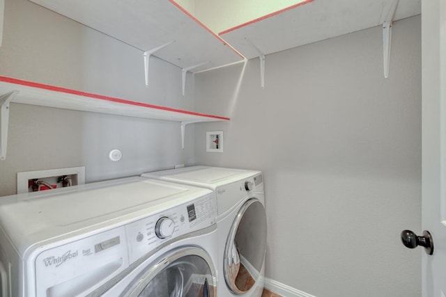 laundry room featuring washer and clothes dryer and baseboards