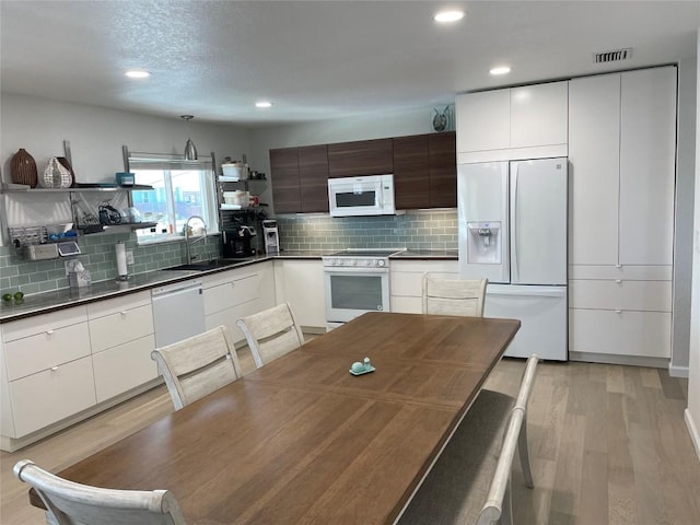 197 Port Saint Claire, Aransas Pass, TX 78336 - kitchen with white appliances, a sink, open shelves, modern cabinets, and recessed lighting