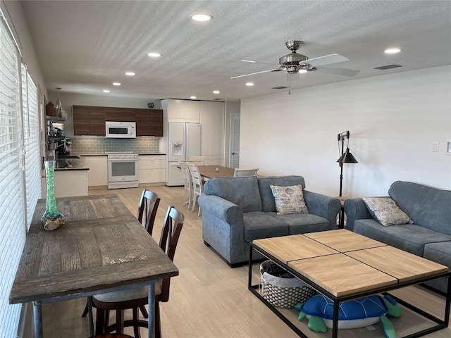 197 Port Saint Claire, Aransas Pass, TX 78336 - living area with light wood-type flooring, a ceiling fan, and recessed lighting