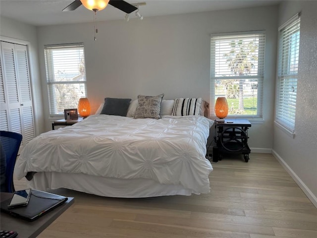 197 Port Saint Claire, Aransas Pass, TX 78336 - bedroom featuring light wood-style floors, a closet, baseboards, and a ceiling fan