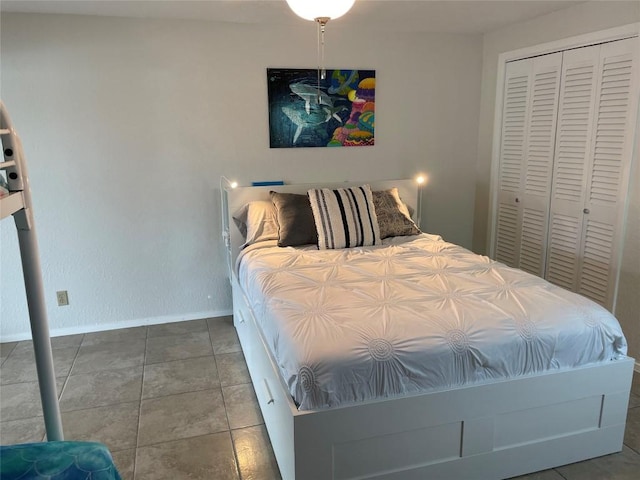 197 Port Saint Claire, Aransas Pass, TX 78336 - bedroom with baseboards, a closet, and tile patterned floors