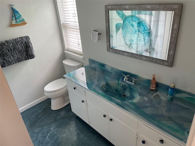 197 Port Saint Claire, Aransas Pass, TX 78336 - bathroom with toilet, vanity, baseboards, and concrete floors