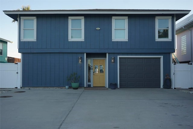 197 Port Saint Claire, Aransas Pass, TX 78336 - view of front facade featuring a garage, driveway, and a gate