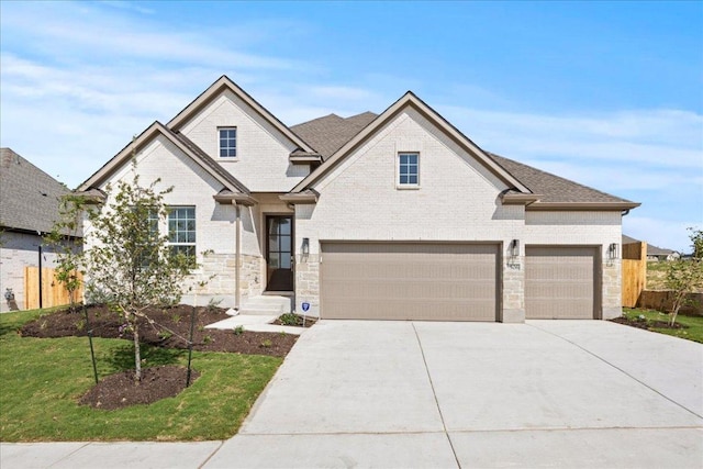 506 Diamondleaf Dr, Buda, TX 78610 - view of front facade with driveway, brick siding, and an attached garage