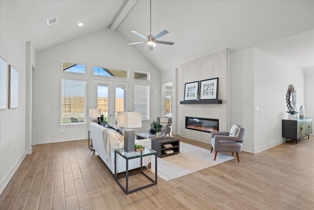 506 Diamondleaf Dr, Buda, TX 78610 - living room featuring beam ceiling, light wood finished floors, baseboards, a fireplace, and ceiling fan
