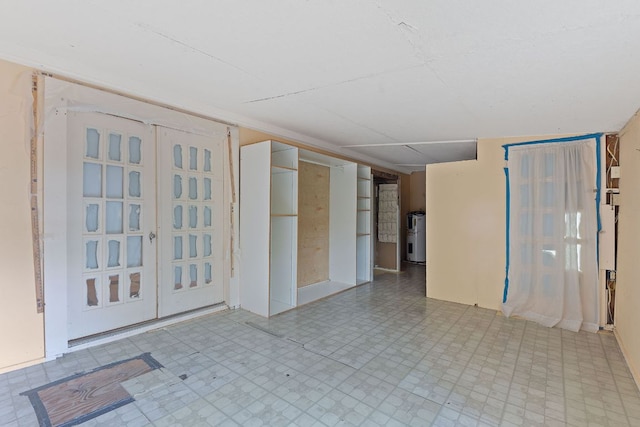 18309 Lake Oaks Dr, Jonestown, TX 78645 - spare room featuring tile patterned floors and water heater