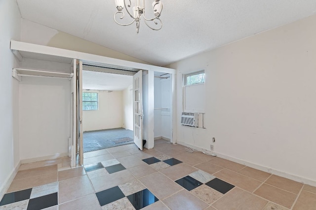 18309 Lake Oaks Dr, Jonestown, TX 78645 - unfurnished bedroom with multiple windows, vaulted ceiling, cooling unit, a chandelier, and baseboards
