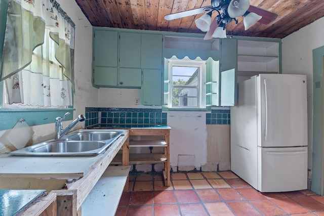 18309 Lake Oaks Dr, Jonestown, TX 78645 - kitchen featuring freestanding refrigerator, wooden ceiling, a sink, ceiling fan, and tile countertops