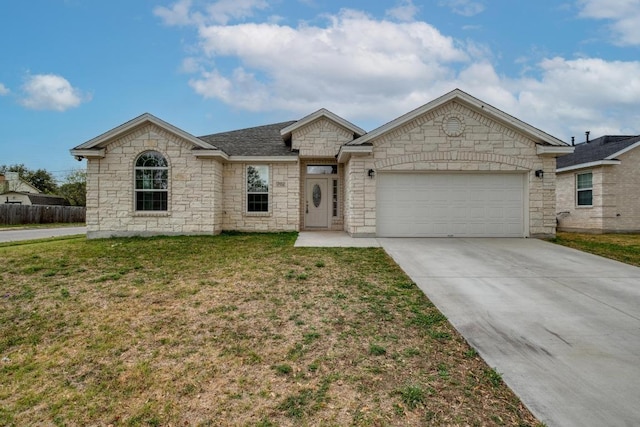 view of front of home with a garage, a front yard, driveway, and stone siding