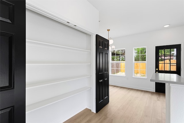 5408 Downs Dr Unit 1, Austin, TX 78721 - doorway to outside featuring light wood-style flooring and recessed lighting