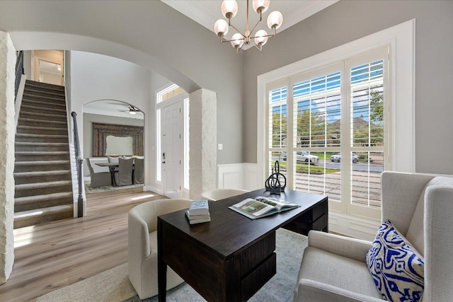 9204 Eddy Cv, Austin, TX 78735 - office space with arched walkways, a chandelier, wainscoting, wood finished floors, and a decorative wall
