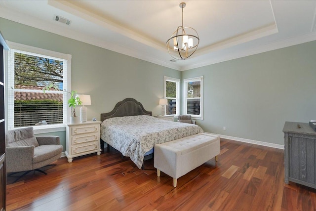 9204 Eddy Cv, Austin, TX 78735 - bedroom with a tray ceiling, multiple windows, a chandelier, ornamental molding, and dark wood-type flooring