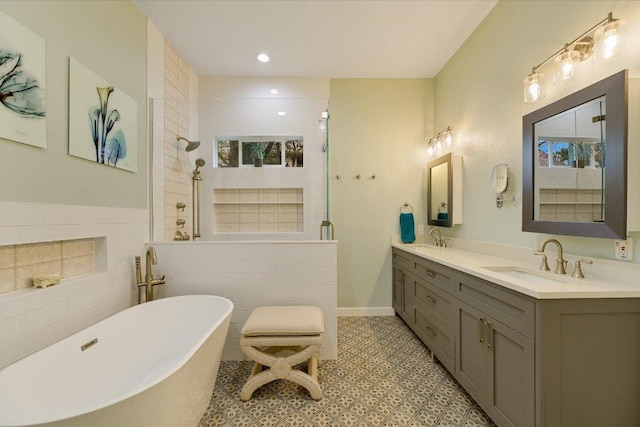 9204 Eddy Cv, Austin, TX 78735 - bathroom with a walk in shower, double vanity, a freestanding bath, tile walls, and recessed lighting