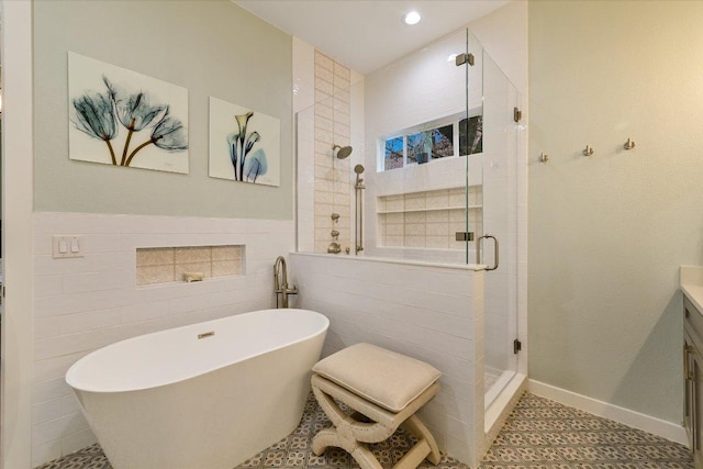 9204 Eddy Cv, Austin, TX 78735 - bathroom featuring a shower stall, a freestanding tub, vanity, tile walls, and recessed lighting