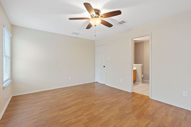 1142 Sundrop Pl, Round Rock, TX 78665 - unfurnished bedroom with light wood-style floors, ensuite bath, and ceiling fan
