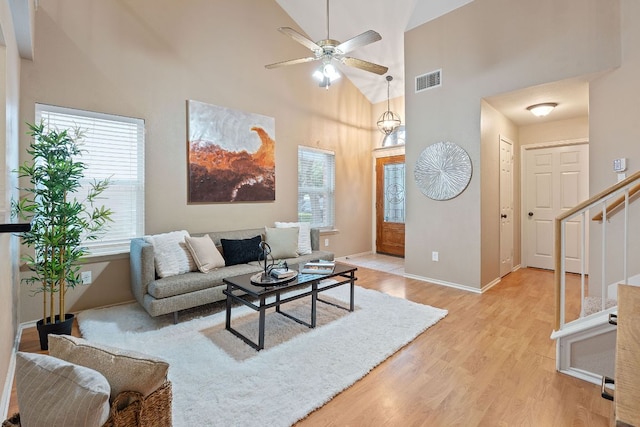 1142 Sundrop Pl, Round Rock, TX 78665 - living room with light wood-type flooring, high vaulted ceiling, a ceiling fan, and stairway