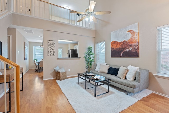 1142 Sundrop Pl, Round Rock, TX 78665 - living area with light wood-type flooring, ceiling fan, and a high ceiling