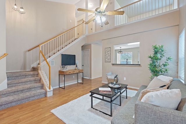 1142 Sundrop Pl, Round Rock, TX 78665 - living area with a towering ceiling, wood finished floors, stairway, and ceiling fan