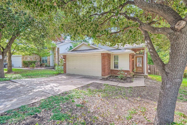 1142 Sundrop Pl, Round Rock, TX 78665 - view of front facade featuring an attached garage, brick siding, and concrete driveway