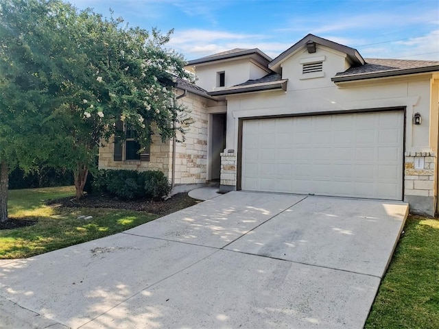 10601 Twisted Elm Dr, Austin, TX 78726 - view of front of house featuring stone siding, an attached garage, concrete driveway, and stucco siding