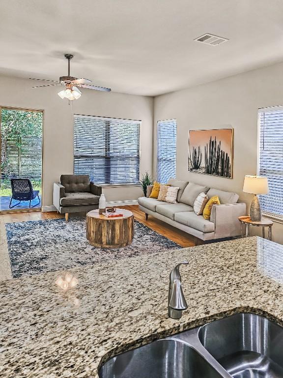 10601 Twisted Elm Dr, Austin, TX 78726 - living room featuring healthy amount of natural light, wood finished floors, and ceiling fan
