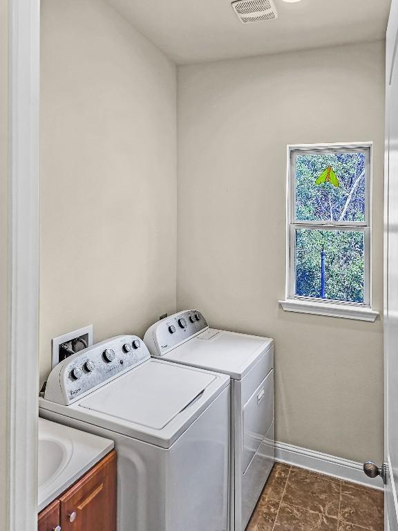 10601 Twisted Elm Dr, Austin, TX 78726 - laundry room with cabinet space and washing machine and dryer
