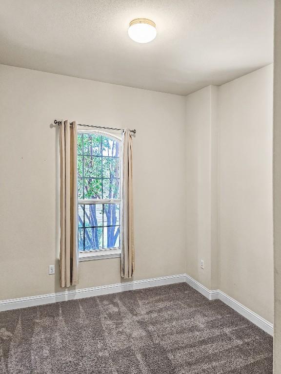 10601 Twisted Elm Dr, Austin, TX 78726 - empty room with dark colored carpet and baseboards