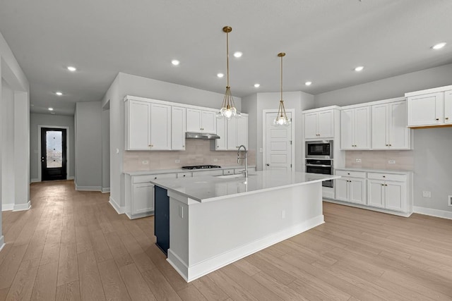 8212 Bouvreuil Dr, Austin, TX 78738 - kitchen with a sink, appliances with stainless steel finishes, light wood-type flooring, backsplash, and recessed lighting