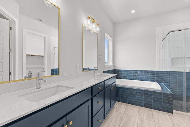 8212 Bouvreuil Dr, Austin, TX 78738 - bathroom with a garden tub, double vanity, a tile shower, and a walk in closet