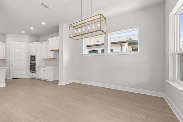 8212 Bouvreuil Dr, Austin, TX 78738 - unfurnished dining area with baseboards, light wood-style floors, plenty of natural light, a chandelier, and recessed lighting