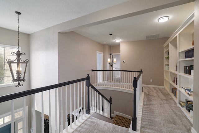 10204 Treasure Island Dr, Austin, TX 78730 - hall with a chandelier, an upstairs landing, and carpet