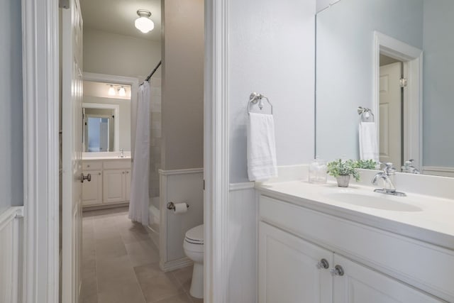10204 Treasure Island Dr, Austin, TX 78730 - bathroom with vanity, wainscoting, shower / tub combo with curtain, and tile patterned flooring