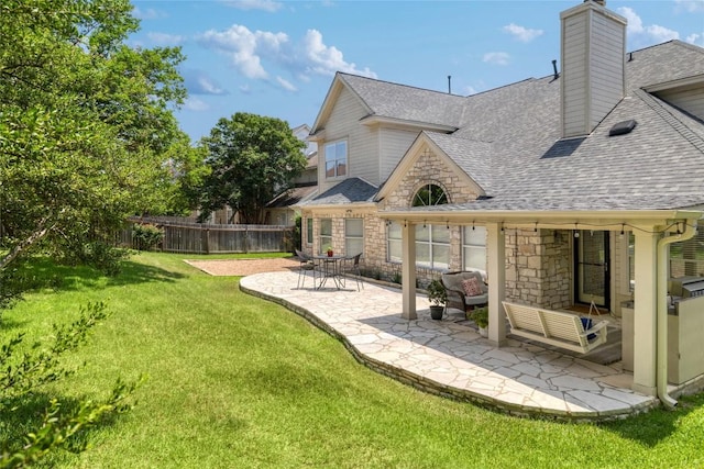 10204 Treasure Island Dr, Austin, TX 78730 - rear view of property with a shingled roof, a patio area, stone siding, and a chimney