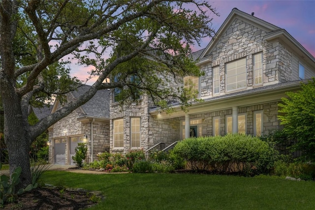 10204 Treasure Island Dr, Austin, TX 78730 - traditional-style home featuring stone siding, a yard, and a garage