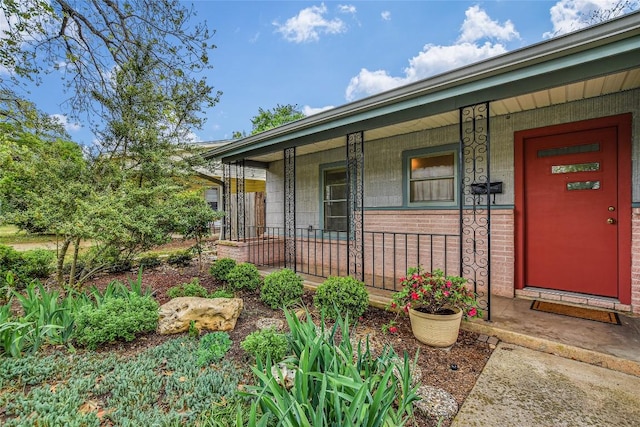 1513 Beckett St, Austin, TX 78757 - doorway to property with covered porch and brick siding