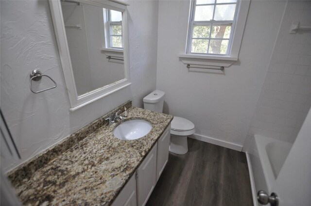 12223 Antoinette Pl, Austin, TX 78727 - bathroom featuring toilet, vanity, baseboards, and wood finished floors