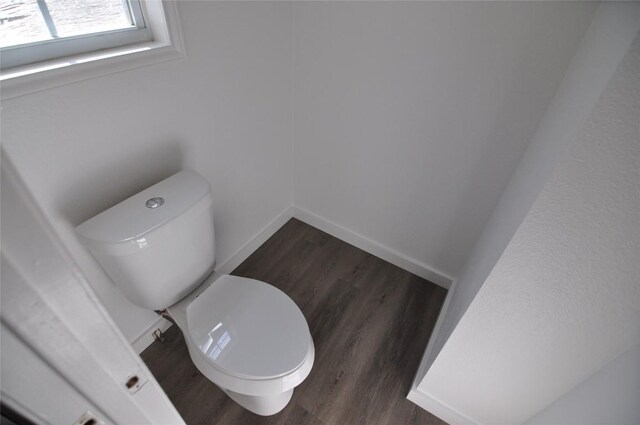 12223 Antoinette Pl, Austin, TX 78727 - bathroom featuring toilet, baseboards, and wood finished floors