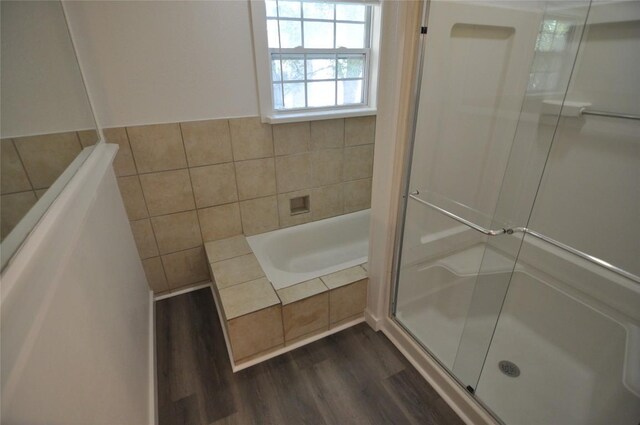 12223 Antoinette Pl, Austin, TX 78727 - full bathroom with a bath, wood finished floors, tile walls, and a shower stall