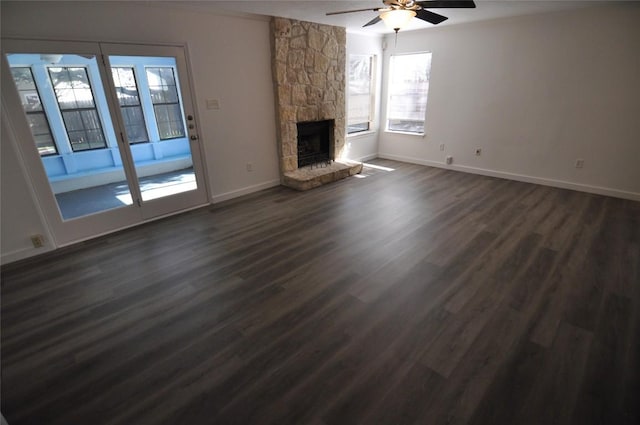 12223 Antoinette Pl, Austin, TX 78727 - unfurnished living room with dark wood finished floors, baseboards, a fireplace, and ceiling fan