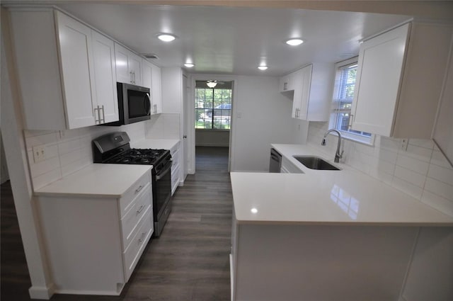 12223 Antoinette Pl, Austin, TX 78727 - kitchen with gas stove, stainless steel microwave, light countertops, dark wood-type flooring, and recessed lighting