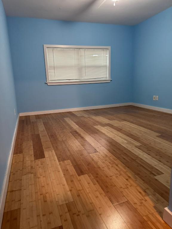 3813 Red Bird Trl, Lago Vista, TX 78645 - unfurnished room featuring hardwood / wood-style floors and baseboards