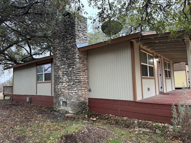 3813 Red Bird Trl, Lago Vista, TX 78645 - view of side of property with a chimney and a deck